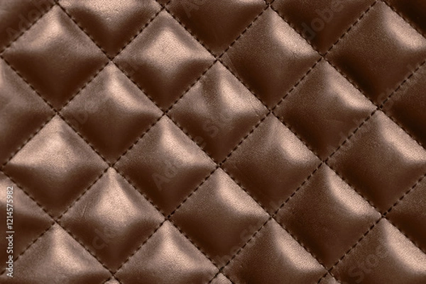 Fototapeta Leather surface in mocha mousse shade with diamond pattern, closeup. Trendy color of 2025 year