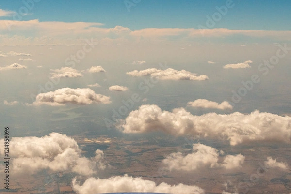 Fototapeta Aerial photograph of clouds outside of my airplane window on a cross country plane trip from Washington DC  to Austin Texas during a turbulent flight