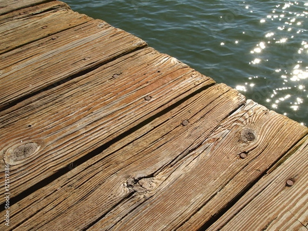 Fototapeta abstract close-up of wooden dock over water