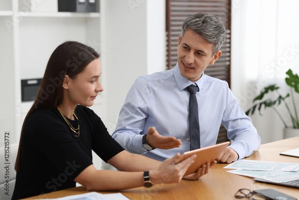 Obraz Coworkers with tablet working at table in office