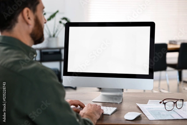 Fototapeta Man working on computer at table in office, closeup