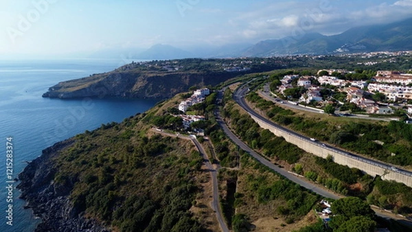 Fototapeta Scenographic aerial view of Calabria Cost with hypnotic blue color sea in summer time