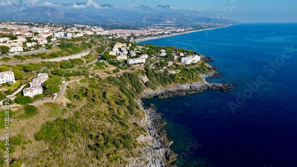 Fototapeta Scenographic aerial view of Calabria Cost with hypnotic blue color sea in summer time