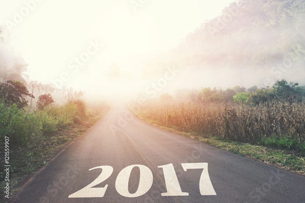 Fototapeta Driving on an empty road towards to upcoming 2017