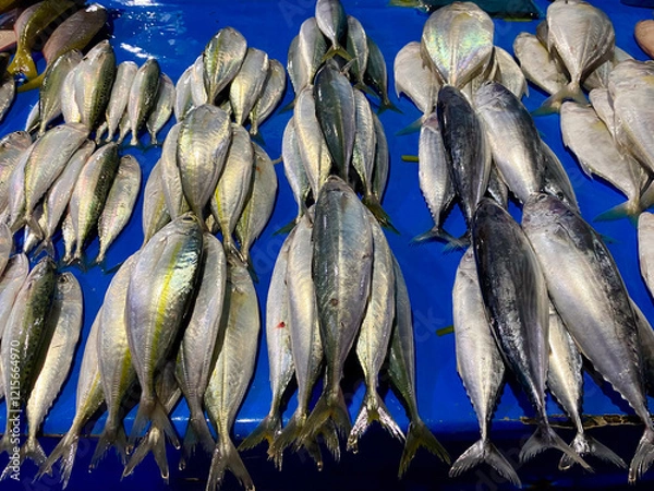 Fototapeta A vibrant display of fresh, glistening fish at a market stall, photographed from a close-up perspective to highlight the textures and colors
