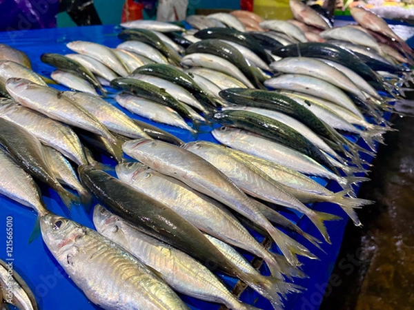 Fototapeta A close-up view of a colorful array of fresh fish on display at a seafood market, showcasing their vibrant textures and colors