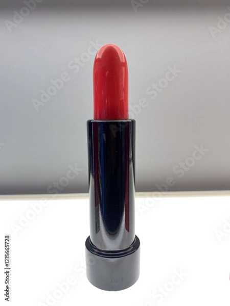 Fototapeta red lipstick on a gray wall background, very popular with women