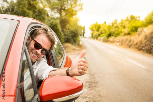 Fototapeta Driver in a car showing thumbs up gesture