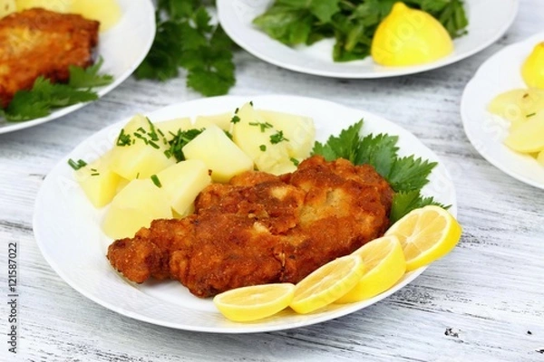 Fototapeta Wiener schnitzel & boiled potatoes, sliced lemon & lettuce