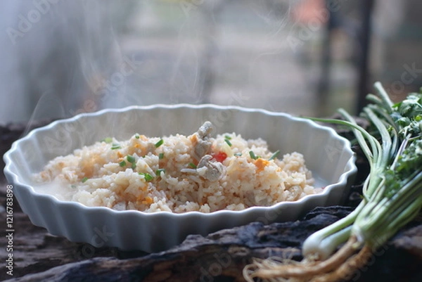 Fototapeta Hot Fried rice with pork and egg in a white plate on a wooden background