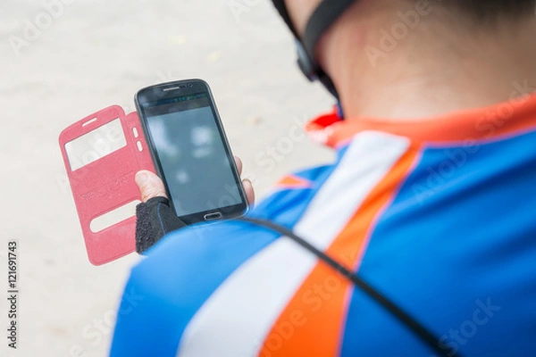 Obraz Bike Messenger using mobile phone
