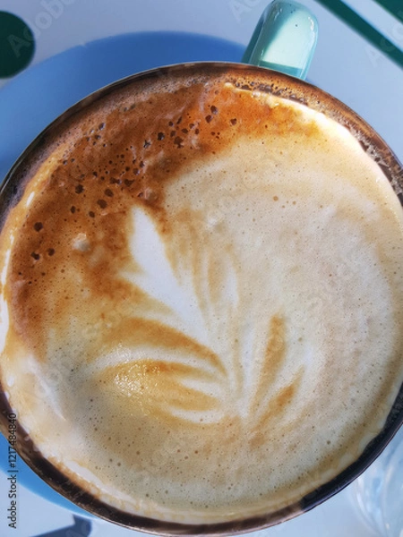 Obraz Close-up of a latte with foam art in a green mug