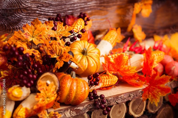 Obraz Autumn still life with marple leaves, vinous berries and october vegetables at the dark wooden background.