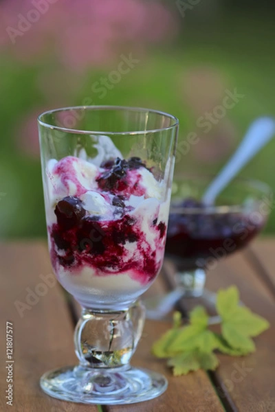 Obraz Glass of ice-cream dessert with black currant jam