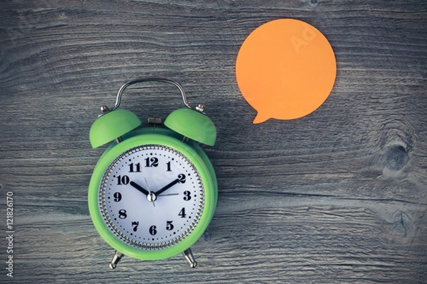 Fototapeta Alarm clock with blank or empty adhesive note