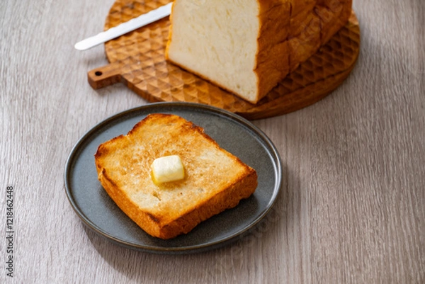 Fototapeta Buttered toast and white bread.
Delicious white bread image.