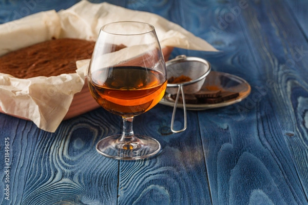 Fototapeta Freshly baked chocolate brownie in square baking tray with paper