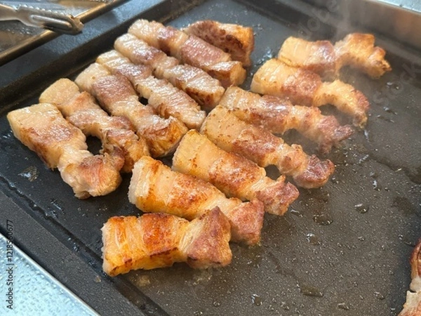 Obraz pork belly being grilled on pan