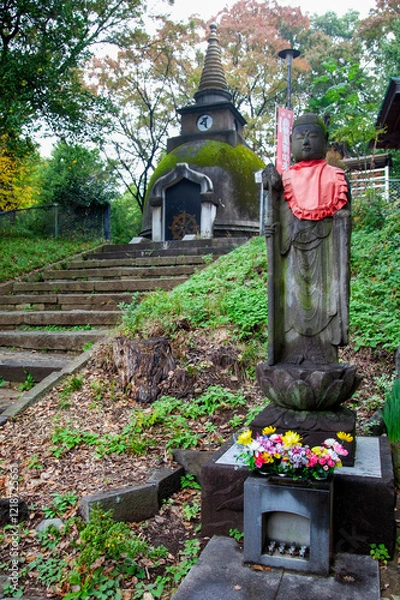 Fototapeta Ueno Daibutsu pagoda at Great Buddha Hill with a Jizo buddha statue in Ueno Park, Tokyo, Japan.