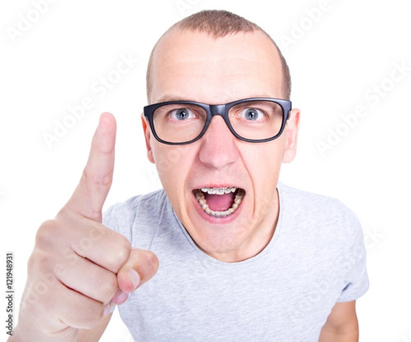 Obraz portrait of angry young man in glasses with braces on teeth scre