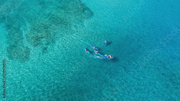 Fototapeta Drone Aerial View of Surfers Riding Waves in Hawaii Sea with Surfboards in the Blue transparent Ocean 