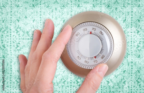 Fototapeta Close-up of a Hand Adjusting a Thermostat Dial With a Lace Background