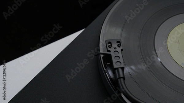 Fototapeta A vinyl record spinning on a turntable, creating music for the atmosphere