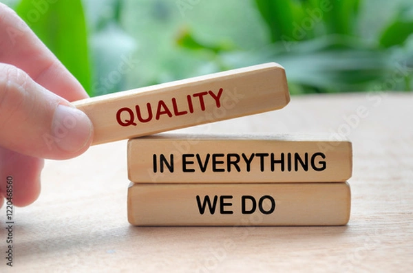 Fototapeta Quality in everything we do text on wooden blocks. Business quality concept