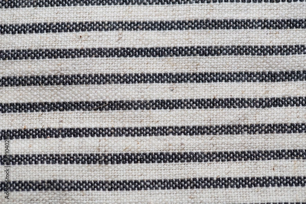 Fototapeta Striped fabric texture with black and white woven lines, showcasing a rustic and natural design. Perfect for backgrounds, textiles, or decorative purposes