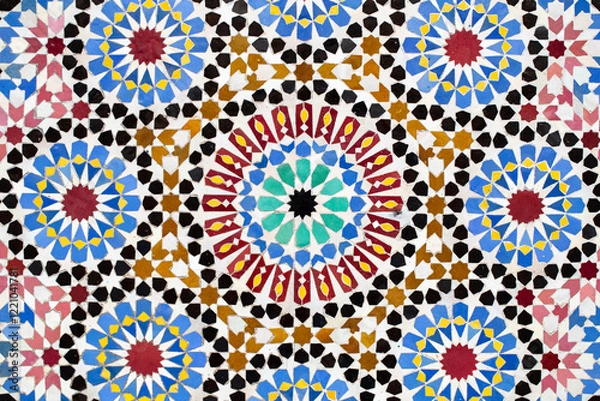 Fototapeta A detailed Islamic geometric mosaic featuring vibrant colors and symmetrical patterns. The design showcases traditional arabesque motifs with star shapes and interwoven lines