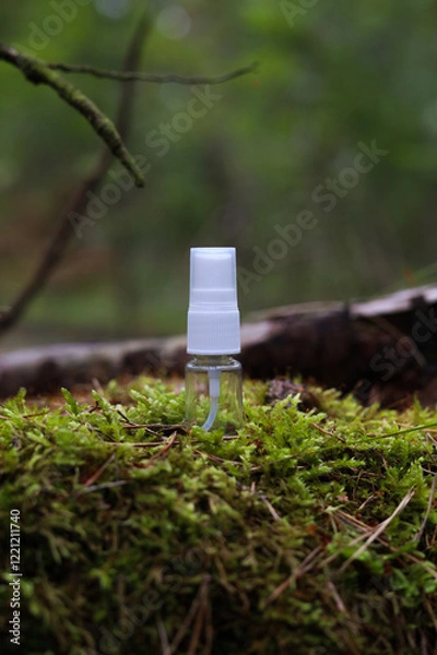 Fototapeta Tube of cosmetics on a stone among the leaves. The concept of natural plant cosmetics. Mockup.