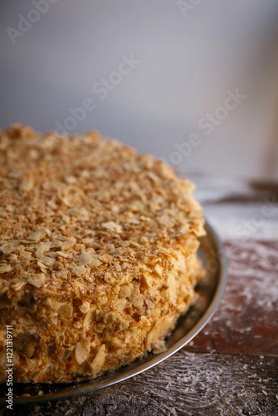 Obraz A close-up of a sumptuous Napoleon cake with multiple flaky layers filled with rich cream