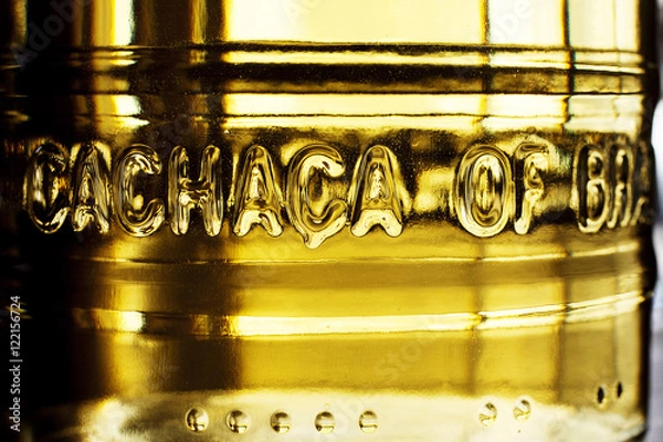 Fototapeta A bottle of cachaca on rustic background with natural light.