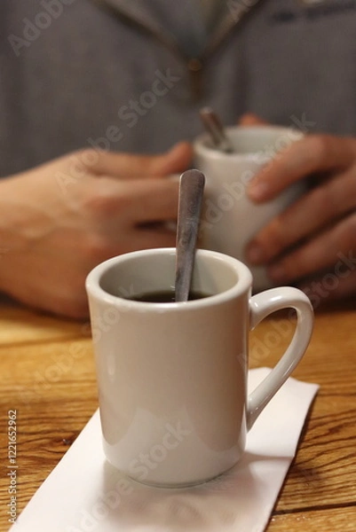 Fototapeta Hot cup of coffee on a table in a retro diner in Columbus, Ohio.