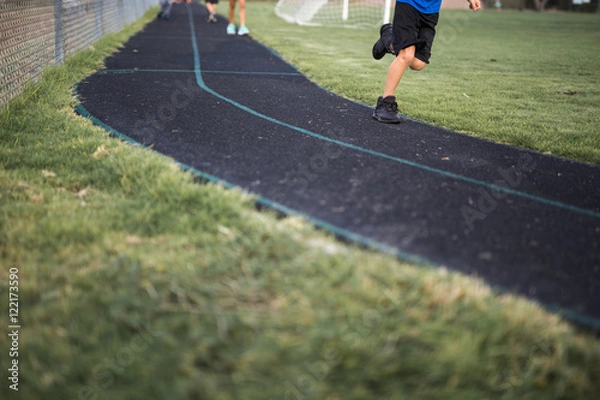 Fototapeta School  kid,boy,child shoes cropped while running on track for exercise 
