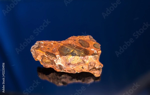 Fototapeta Radial blurred background view of bauxite mineral under sun light on black background
