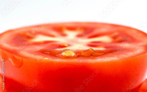 Fototapeta Sliced red tomato on white background. Round piece of fresh tomato. Macro background.