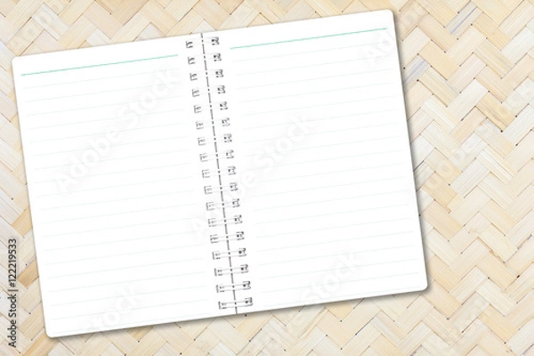 Fototapeta Open notebook paper with line on bamboo weave background for design with copy space for text or image.