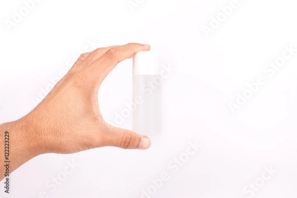 Obraz Man hand holding a small tube cream on white background