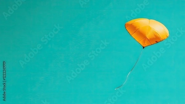 Fototapeta Yellow Balloon Floating Against a Bright Blue Sky Creating a Sense of Joy and Freedom