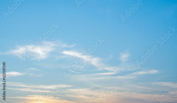 Fototapeta the sky is clear with fiuffy wthite clouds and beautiful orange light.