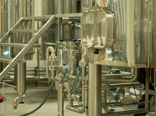 Fototapeta A small industry brewery's brewing tanks in a brewery that produces craft beer