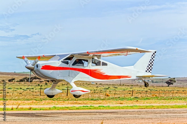 Fototapeta White and red high wing home-built single engine kit aircraft with four seats and fixed undercarriage taking off from an airstrip in the Western Cape, South Africa