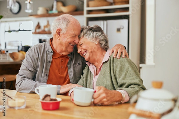 Fototapeta Lovely old couple embracing and smiling in kitchen