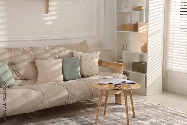 Fototapeta Beautiful sofa with cushions and coffee table in living room. Interior design