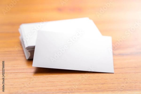 Fototapeta Blank mock up (business card) and cup of coffee on wooden background. Mock up for design