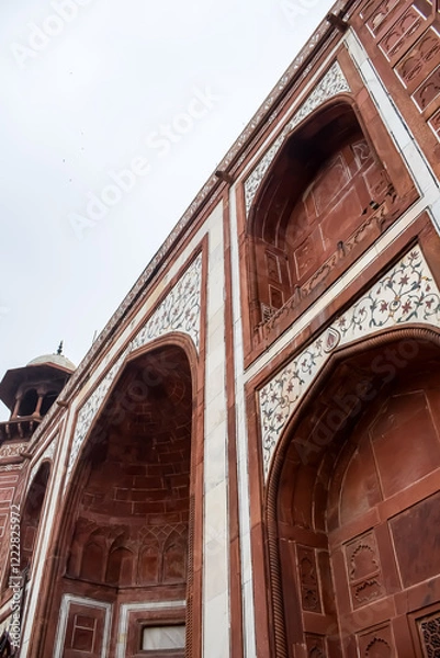 Fototapeta Amazing architecture view at Taj Mahal which is among seven world wonders. Famous Indian Islamic heritage at cloudy day, Taj Mahal located at bank of Yamuna river