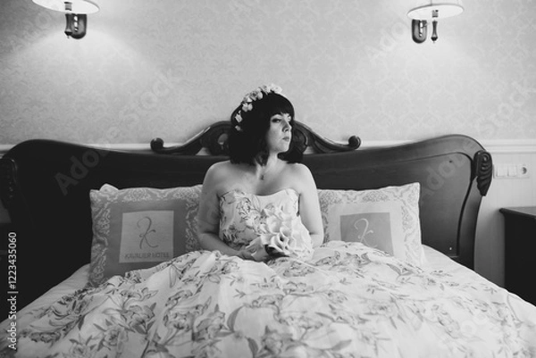 Fototapeta Gorgeous bride in robe posing and preparing for the wedding ceremony face in a room