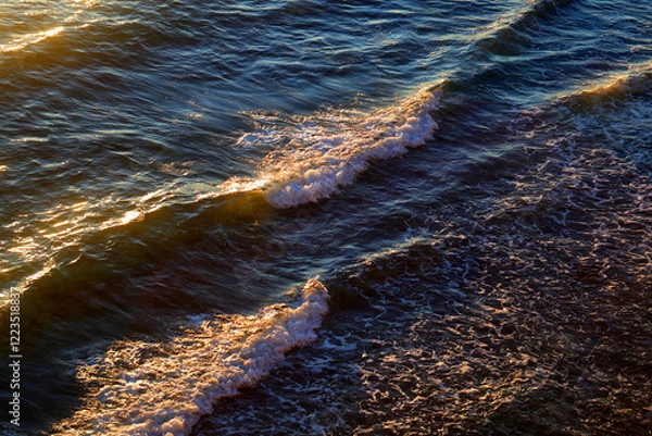 Obraz Photos of sea waves moving at sunset