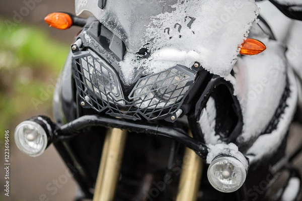 Fototapeta A large black touring motorcycle is covered in snow. The end of the motorcycle season, winter. The inscriptions "Stupid snow, No, WTF" symbolize stubbornness and the desire to continue traveling
